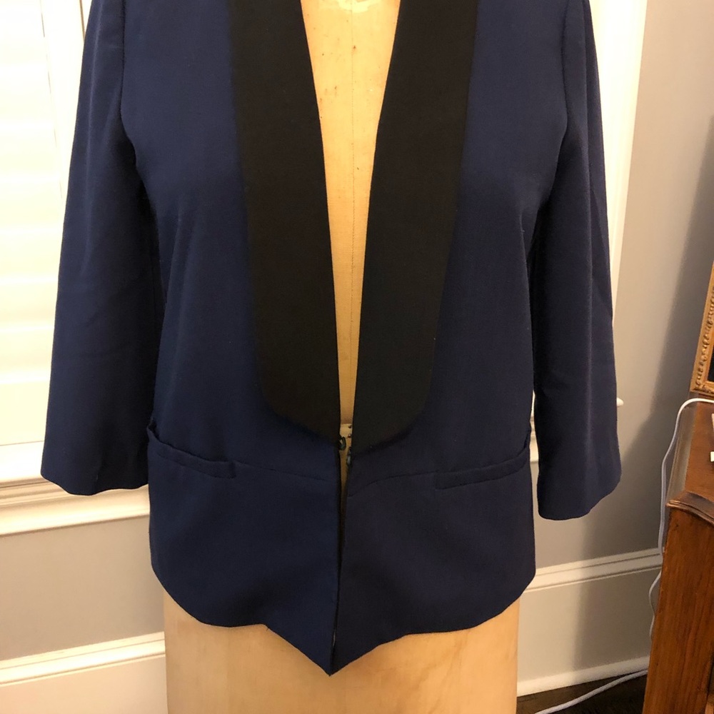 Blue jacket with a black label